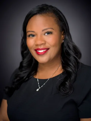Photo of Brittany Banks against a dark background