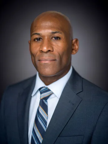 Photo of Chico Bennett against a dark background